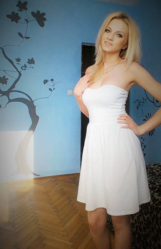 Blonde, braless in white dress.