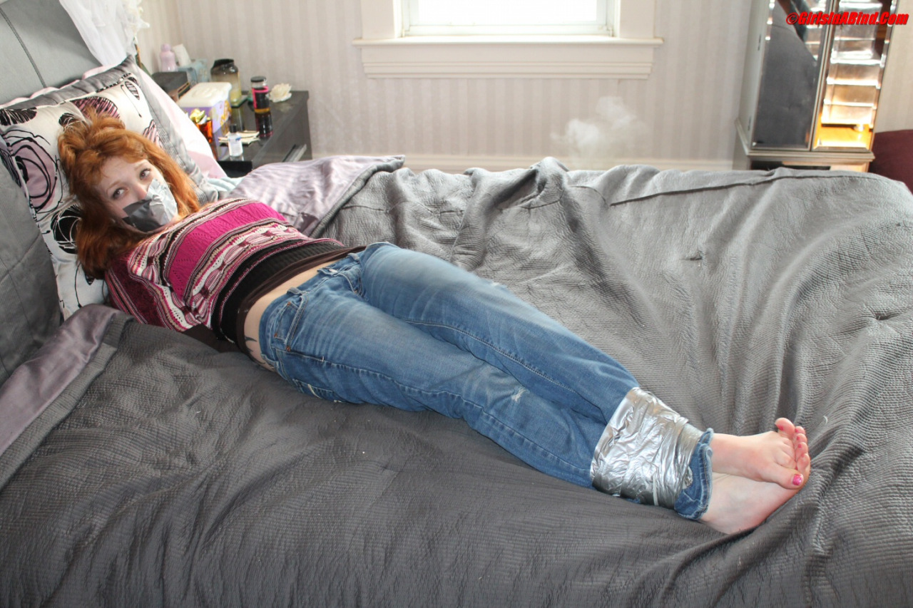 Securely bound up with duct tape, and with a knife to her throat, Stacy had no choice but provide her bank account information to her captor. Adding more tape, she put Stacy in an inescapable hogtie, to make sure she stayed put while she headed of to the