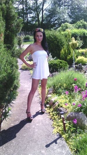 Dark hair bimbo wearing really short white dress and high heels