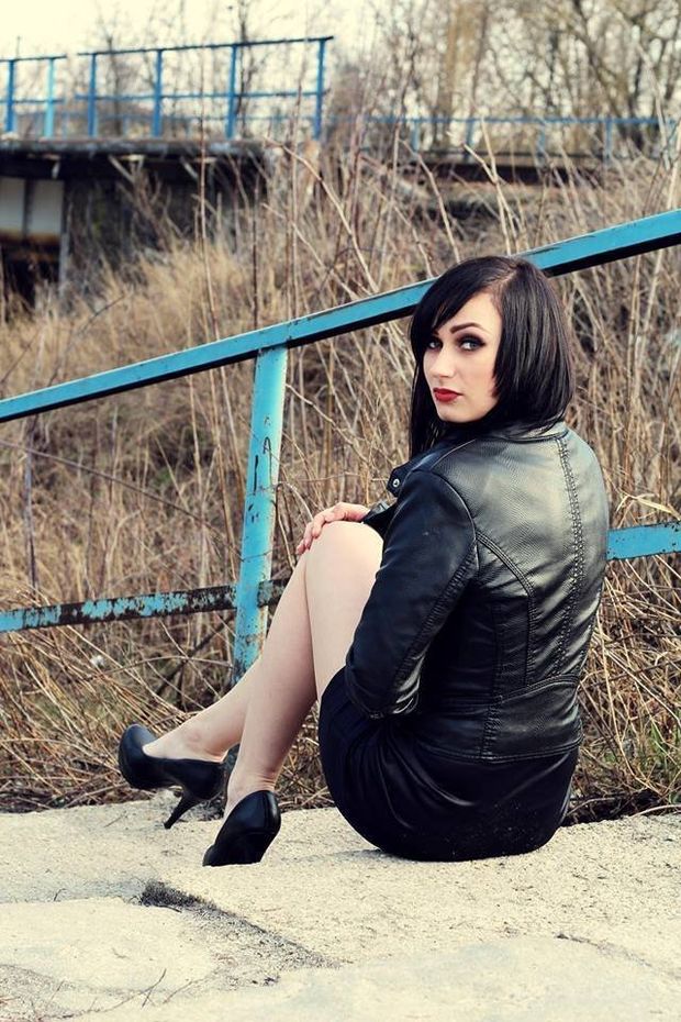 Goth babe outdoors, leather jacket, short skirt and sexy long legs.