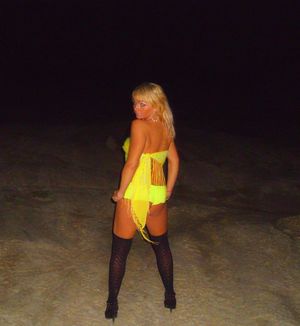 Tanned blonde slut before foursome at the beach