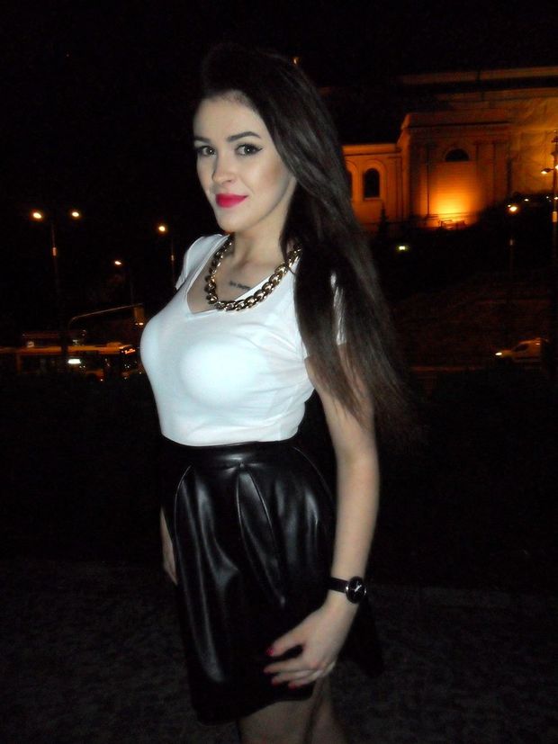 Hot brunette in sexy outfit posing on the street