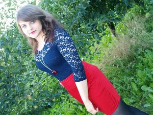 Amateur brunette posing outdoors in lace blouse and red pencil skirt