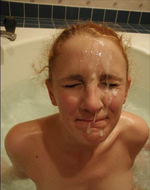 Facial on red head in bath.