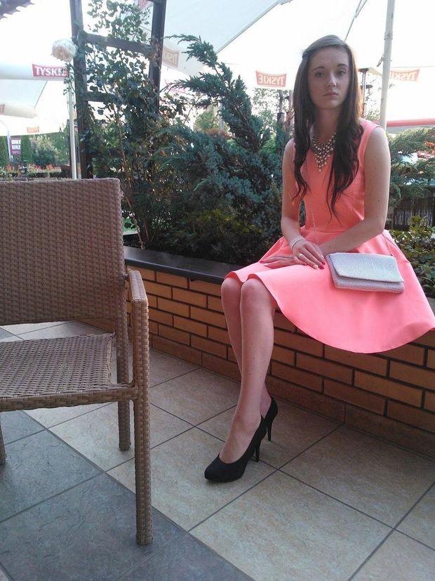 Young cute brunette in pink dress