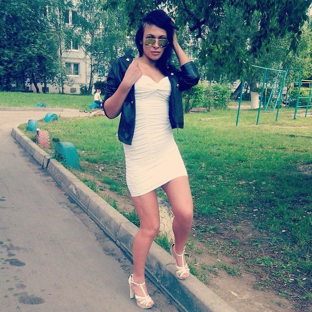 Leggy bimbo outdoors in tight white dress