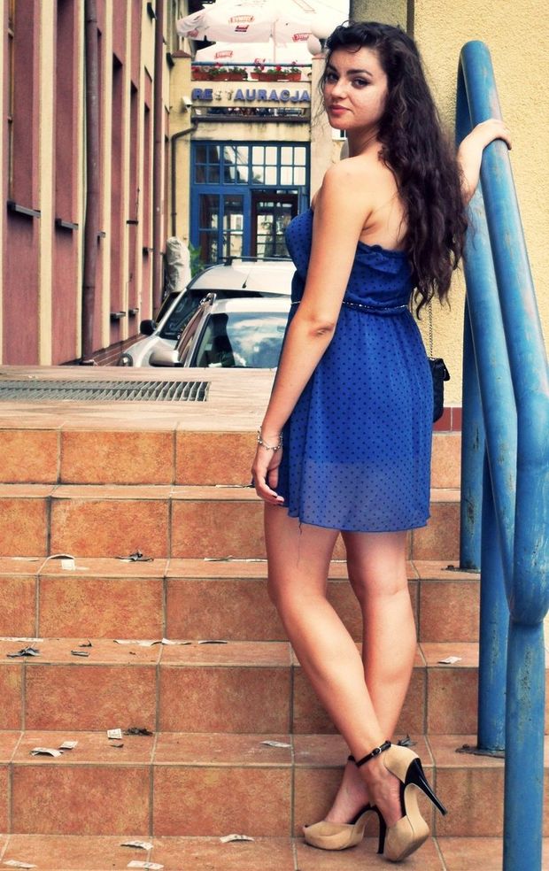 Hot dark hair chick posing outdoors in mini see thru blue dotted dress and heeled sandals