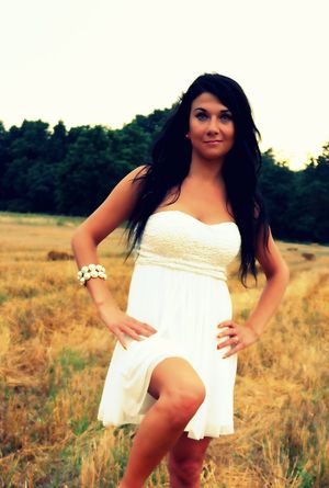 Sexy tanned brunette at the countryside