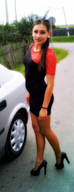 Hot leggy brunette in tight black'n red dress and high heels