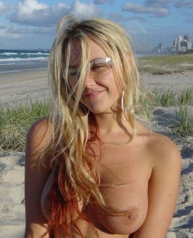 Blonde topless posing on the beach
