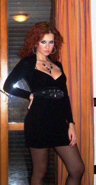 Sexy redhead chick with nice rack wearing tight mini black dress