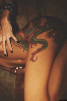 Hot tattooed dragon gif this girl is naked and show her dragon tattoo on her leg