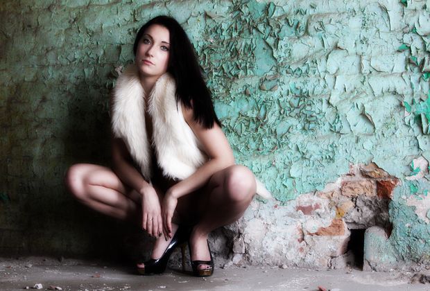 Nude brunette posing in some abandoned building