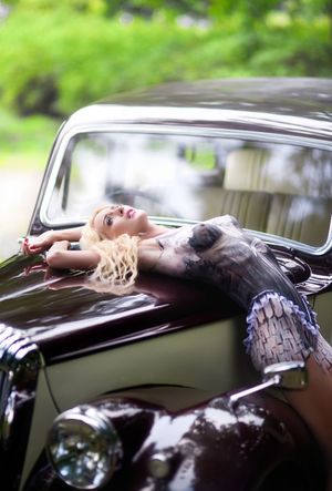 Bodypainted blonde model posing outdoors