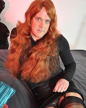 Fiery red haired TRANSWOMAN posing on her big the sack &#038; looking sensual.       See ALL of the good stuff from this post by clicking here.     Click here to watch free video samples compliments of Tranz Mania.        Like What You've Seen So Far?