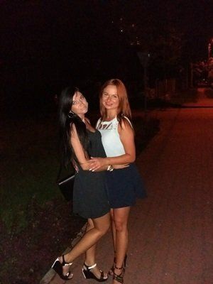Sexy redhead and her brunette friend outdoors