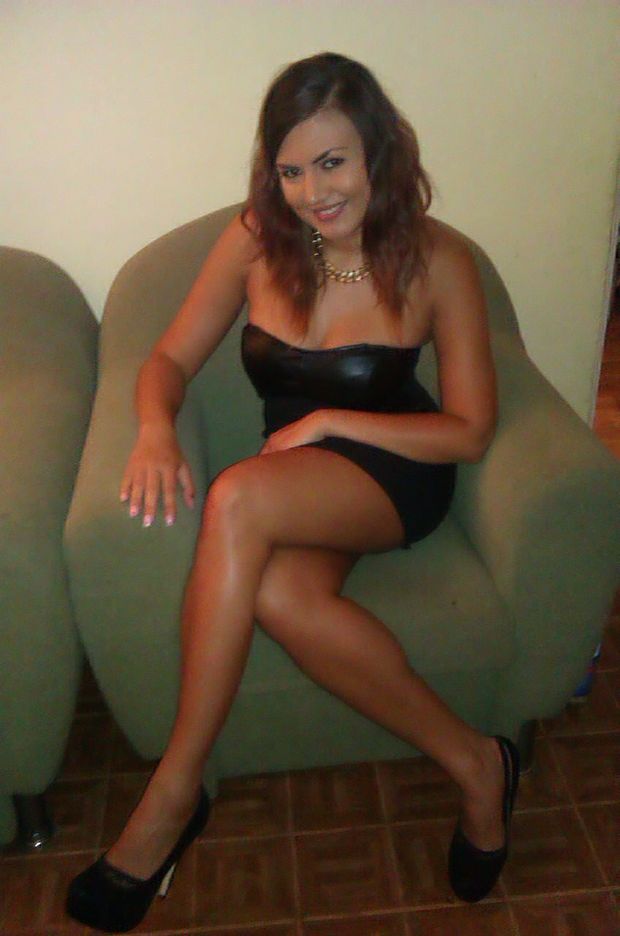 Nice tanned chick in sexy mini leather dress and high heels