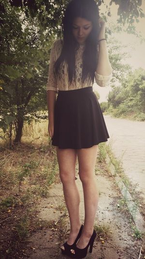 Nice lace shirt and mini skirt on sexy brunette posing outdoors in high peeptoe heels