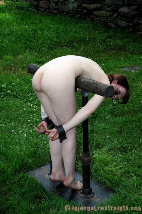 bent over a rail and shackled in place
