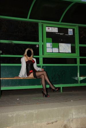 Nasty blonde posing at the bus stop, at night just in sexy lingerie, stockings and high heels