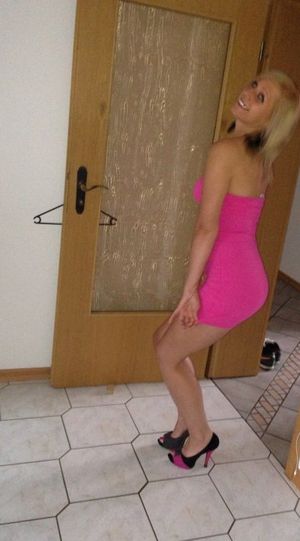 Blonde bimbo in pink mini dress redy to go out