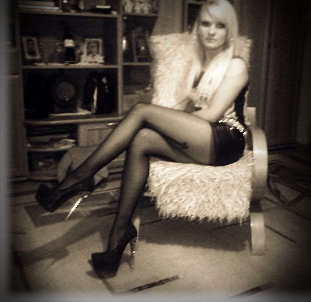 Blonde bimbo in high heels and slutty short skirt