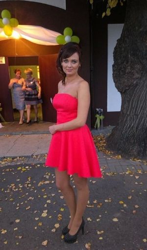 Party babe in nice mini braless dress and high heels posing outdoors