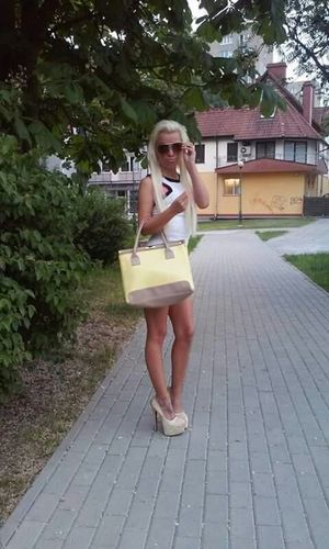 Blonde bimbo outdoors in extreme high heels