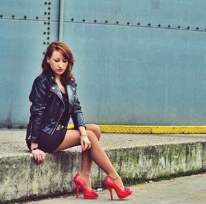 Redhead hottie posing outdoors in red high heels and tight mini dress