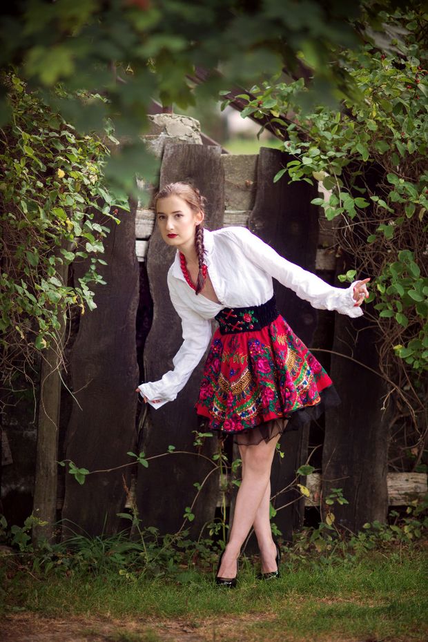 Blonde model in folk outfit posing outdoors