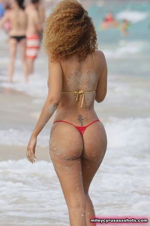 sexy ebony big booty on the beach in a tiny red thong
