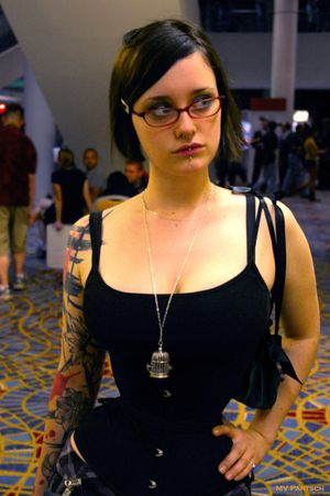 americancomicon:Corset Girls with Glasses: Simone. ~Dragon*Con. Atlanta. 2010. Marriott Marquis: Marquis Level: Escalators Pathway. 