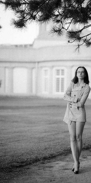 Outdoors in coat and high heels