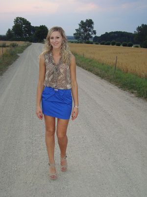 Blonde babe in sexy outfit on the country road