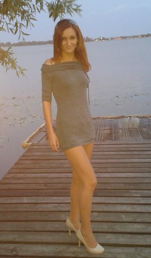 Redhead chick in mini dress on the pier