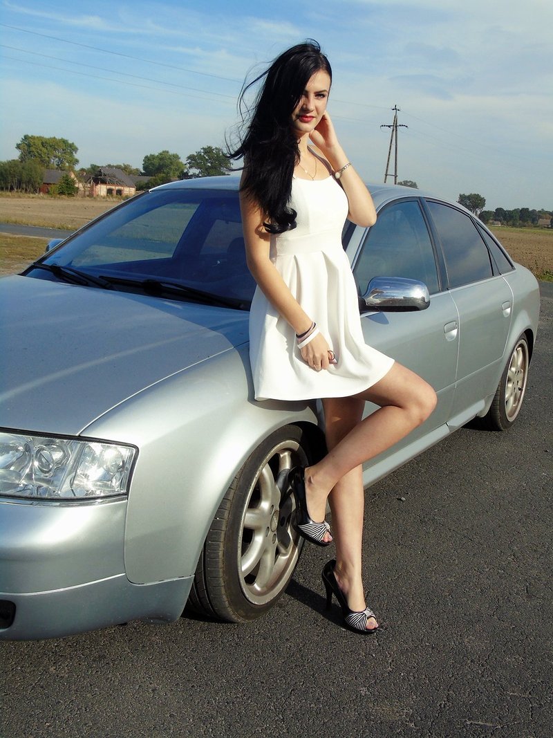 Posing in white dress and with a car