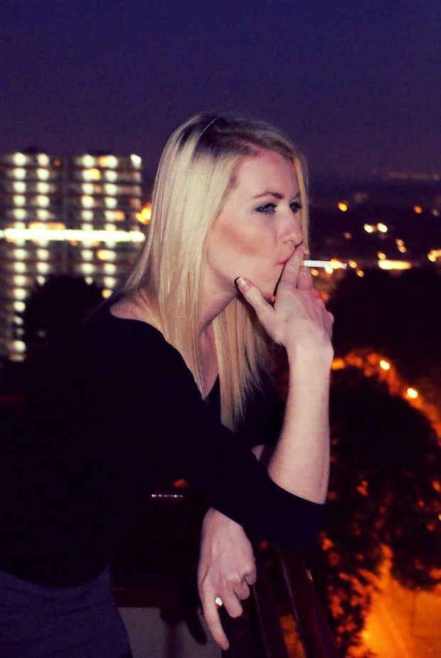 Nice blonde smoking outdoors