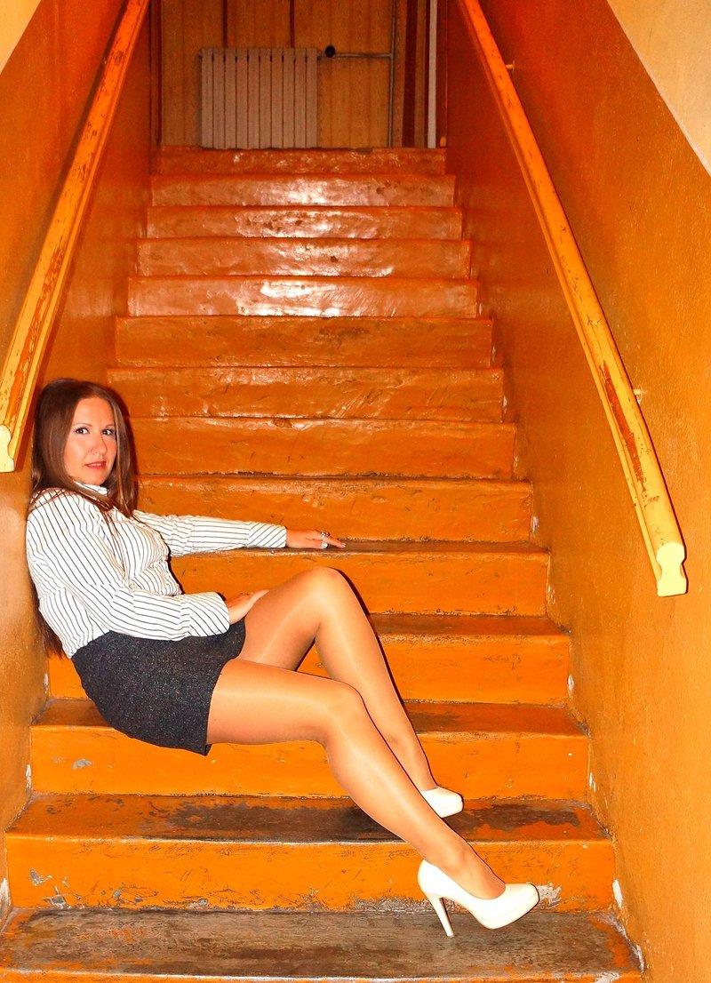 Bored mature secretary hooking at the staircase