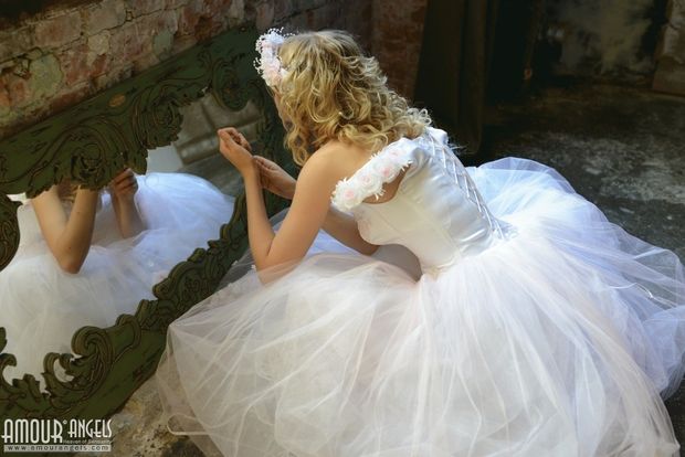 Nika model in wedding dress looking in mirror