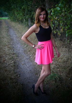 Nice redhead girl posing outdoors in sexy outfit