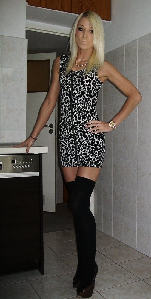 Blonde bimbo at home wearing tight mini dress and knee highs