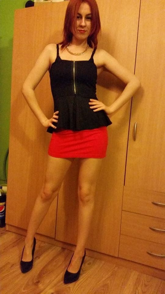 Redhead rookie in sexy outfit posing at home