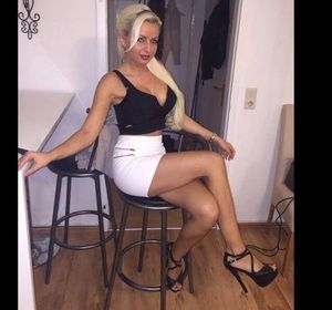 Busty and leggy blonde bimbo posing at home before going out