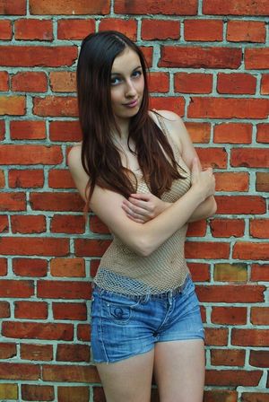 Rookie posing in sexy fishnet blouse and jeans shorts