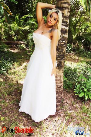 Tranny Angeles Cid poses in a wedding dress that shows plenty of cleavage. Dress is for sale!