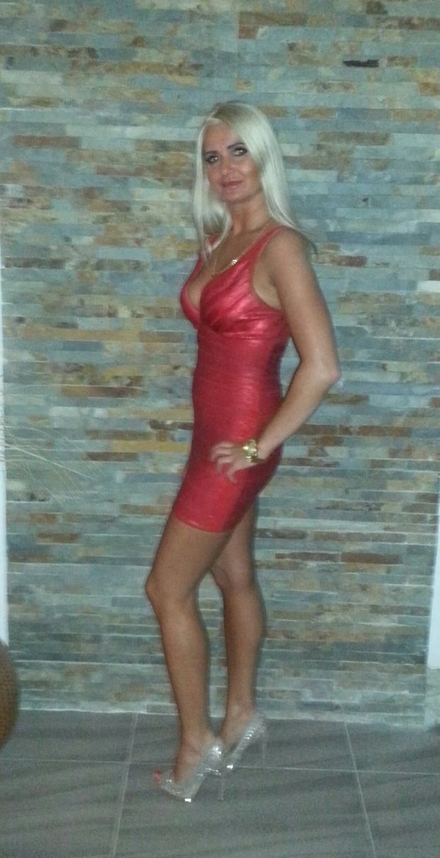 Busty blonde bimbo in tight and sexy, red minidress and sparky high heels