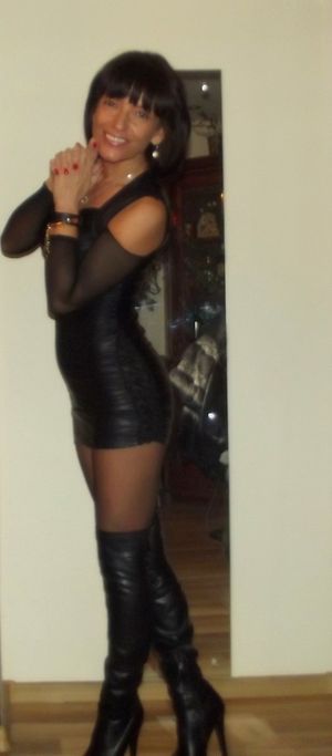 Dark hair mature in tight leather outfit and black boots