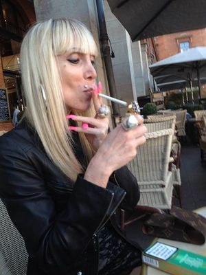 Mature blonde street walker smoking... cigarette