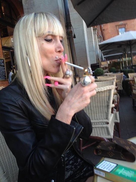 Mature blonde street walker smoking... cigarette