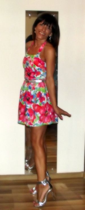 Tanned brunette mature in mini dress and sliver heeled sandals